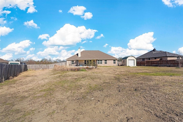 back of property featuring an outbuilding and a yard