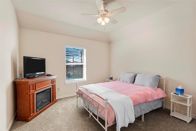 bedroom with ceiling fan, lofted ceiling, and carpet flooring