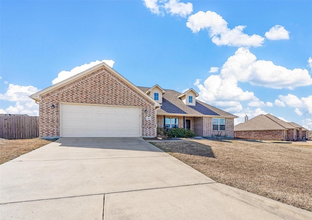 view of front of property featuring a garage and a front lawn