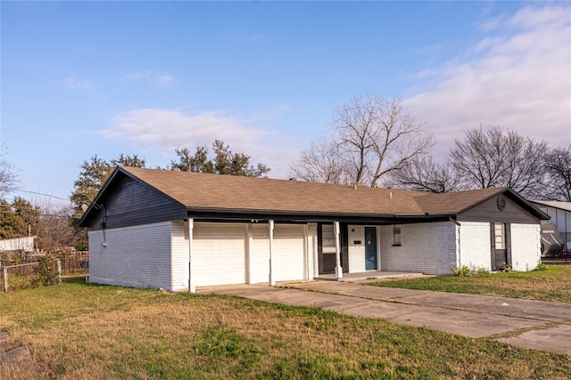 ranch-style home with a front lawn and a garage