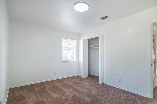 unfurnished bedroom with a closet and carpet