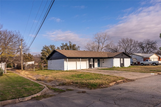 view of front of property with a garage and a front yard