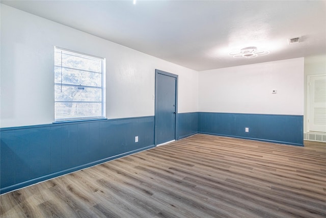 spare room with wood-type flooring