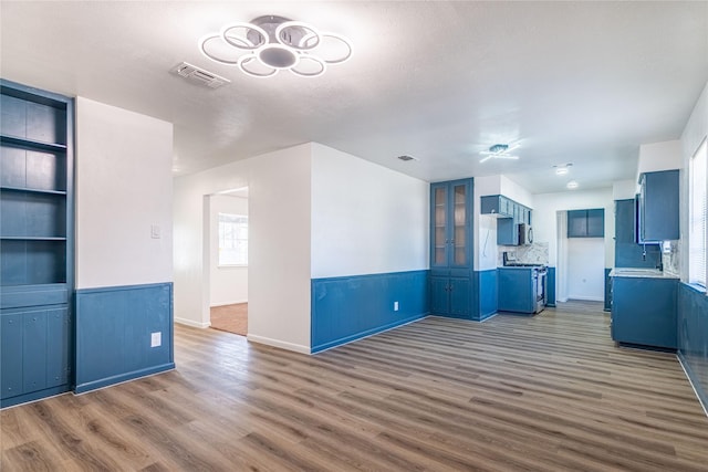 unfurnished living room with dark wood-type flooring and built in features