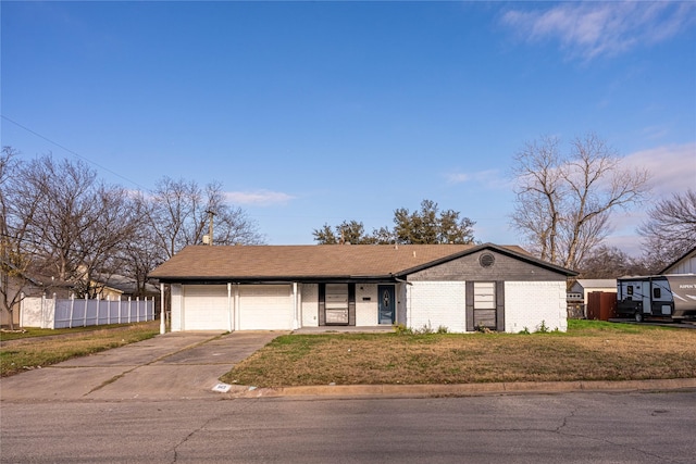 view of front of property featuring a front yard and a garage