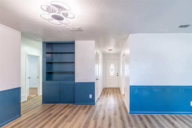 entryway featuring a textured ceiling and hardwood / wood-style floors