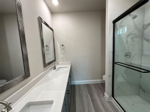 bathroom featuring vanity, toilet, hardwood / wood-style flooring, and walk in shower