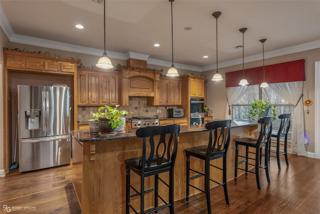 kitchen featuring a kitchen island, a kitchen breakfast bar, and stainless steel refrigerator with ice dispenser