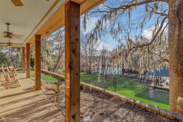 exterior space with a yard and ceiling fan