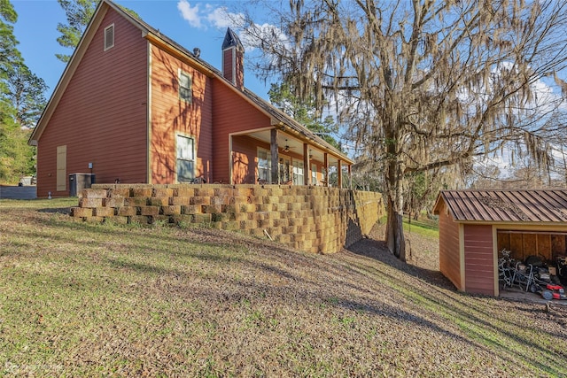 view of home's exterior with a garage, a yard, and central air condition unit