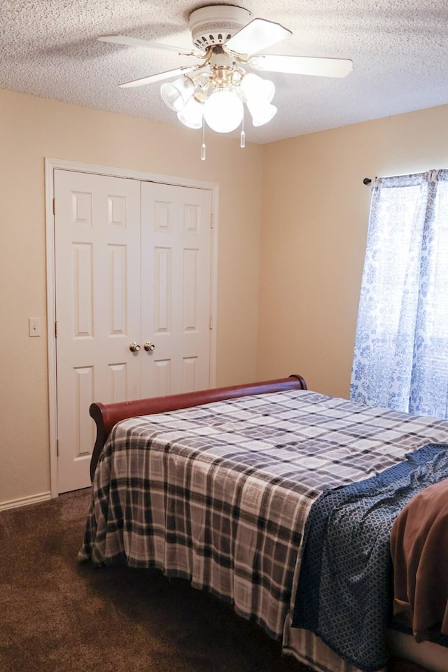 carpeted bedroom featuring a textured ceiling, ceiling fan, and a closet