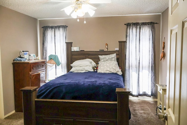 bedroom featuring ceiling fan, a textured ceiling, and carpet flooring