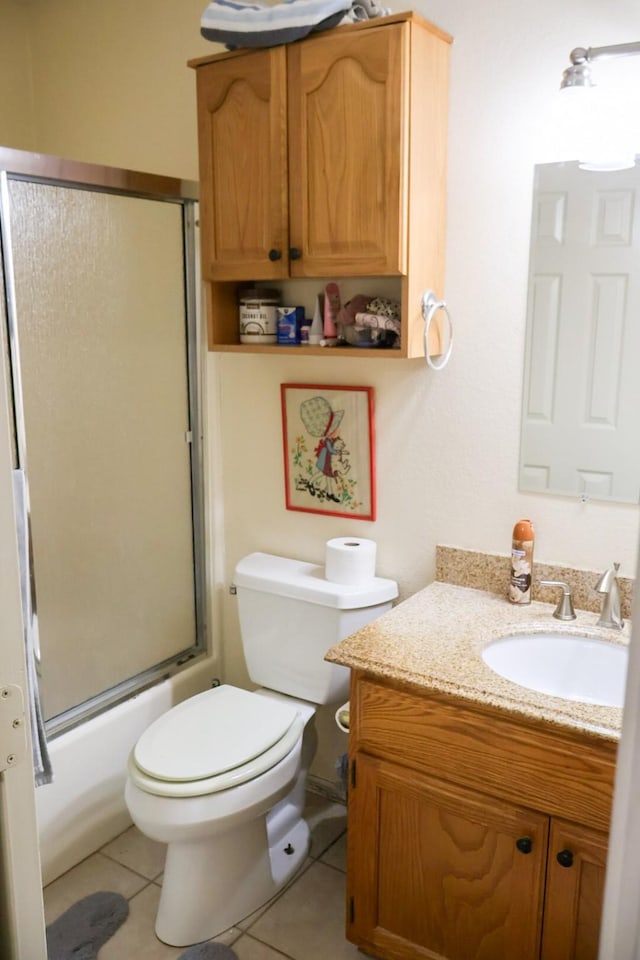 full bathroom with toilet, bath / shower combo with glass door, tile patterned floors, and vanity