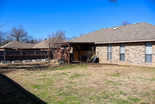 back of house featuring a yard