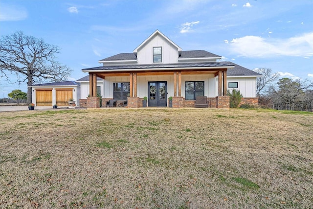 view of front of house with a front lawn, a porch, and french doors