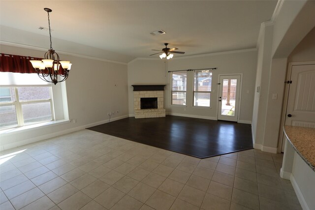 kitchen with a fireplace, a sink, open floor plan, decorative light fixtures, and crown molding