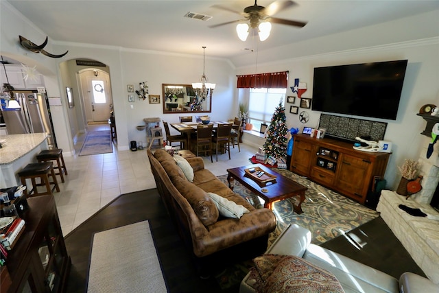 tiled living room featuring ceiling fan with notable chandelier and ornamental molding