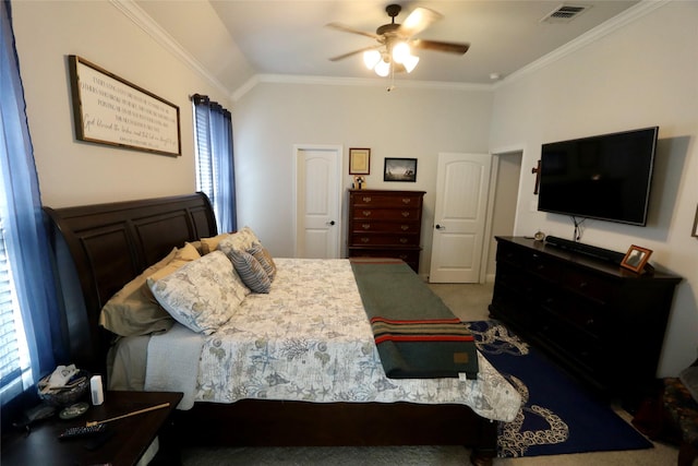 carpeted bedroom with ceiling fan, crown molding, and lofted ceiling