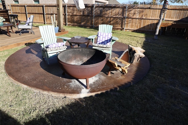 view of yard with a wooden deck and an outdoor fire pit