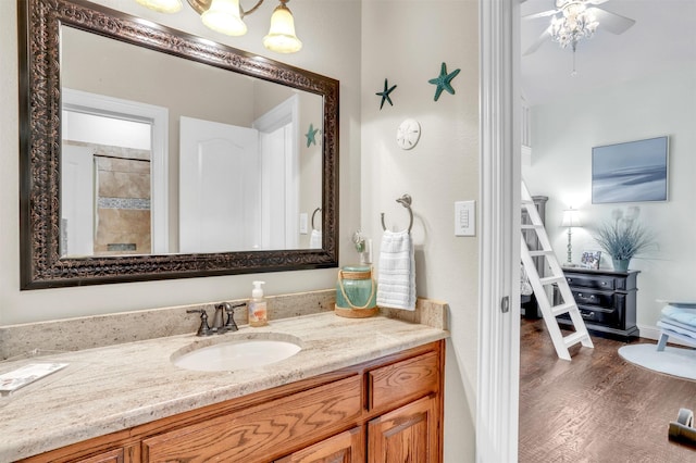 bathroom with ceiling fan, hardwood / wood-style flooring, and vanity