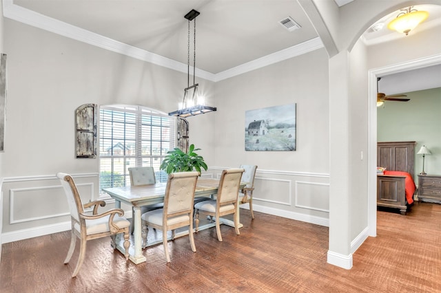 dining room featuring ceiling fan, crown molding, and hardwood / wood-style floors