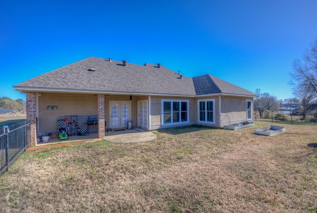 back of house with a yard and a patio area