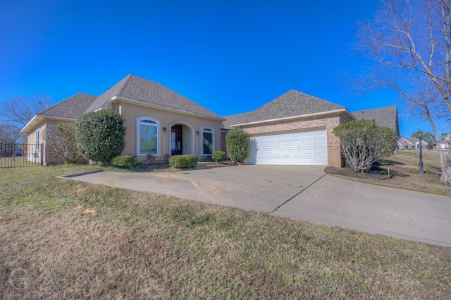 view of front of home with a garage and a front lawn