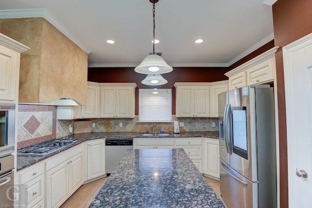 kitchen featuring sink, decorative light fixtures, dark stone countertops, appliances with stainless steel finishes, and decorative backsplash