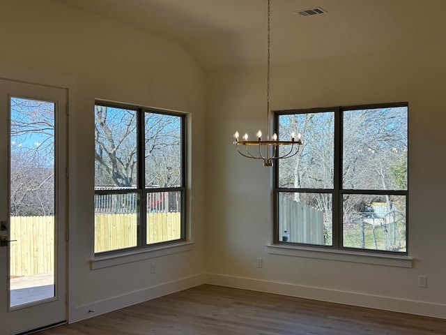 unfurnished dining area with baseboards, vaulted ceiling, visible vents, and dark wood finished floors