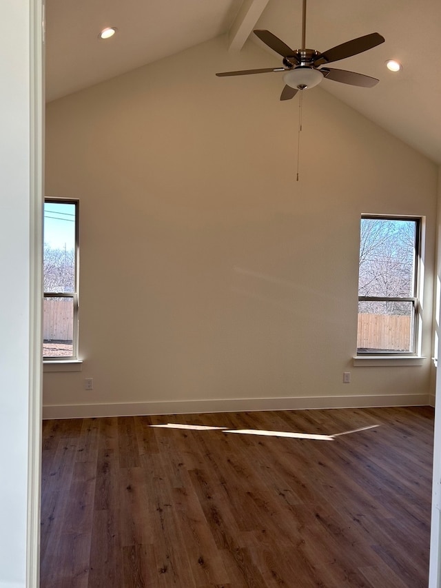 unfurnished room featuring beamed ceiling, wood finished floors, a wealth of natural light, and baseboards