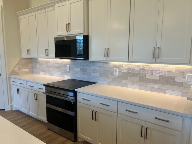 kitchen featuring light hardwood / wood-style floors, tasteful backsplash, stainless steel electric range, white cabinets, and light stone counters