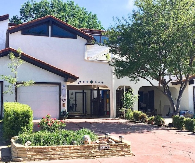 mediterranean / spanish-style home featuring a garage