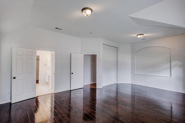 unfurnished room with dark hardwood / wood-style flooring