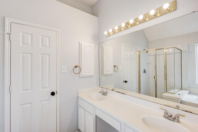 bathroom featuring vanity, vaulted ceiling, and shower with separate bathtub