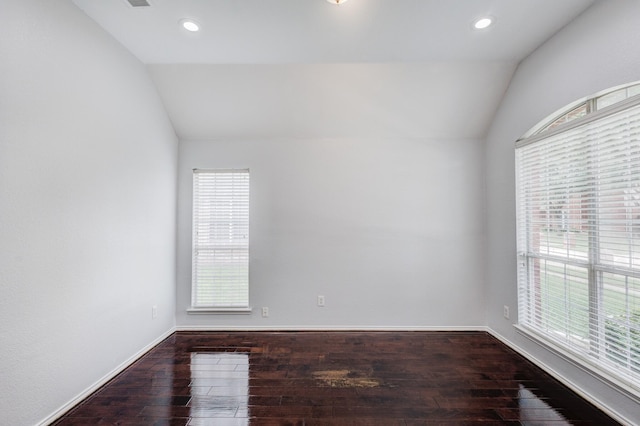 unfurnished room featuring dark wood-type flooring and vaulted ceiling