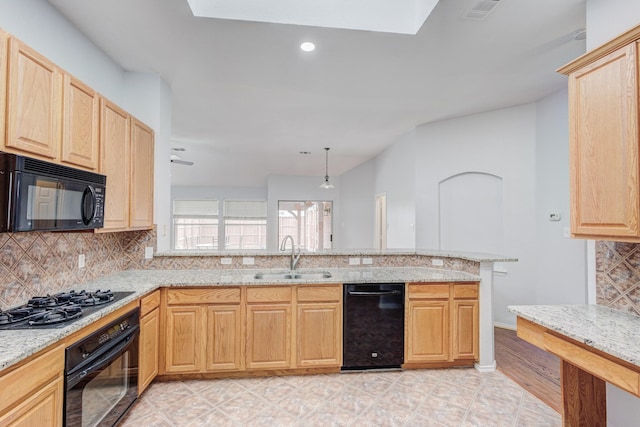 kitchen featuring black appliances, kitchen peninsula, sink, and tasteful backsplash