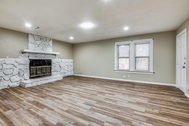 unfurnished living room featuring light hardwood / wood-style flooring and a fireplace