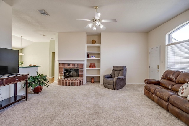 living room with ceiling fan, a brick fireplace, vaulted ceiling, and light carpet