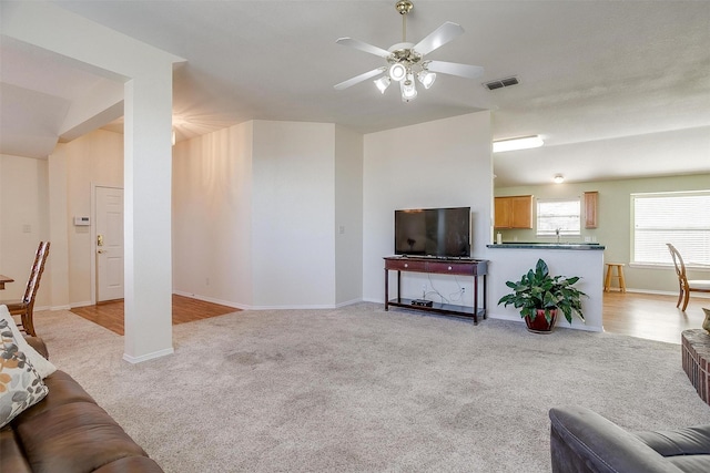 living room with ceiling fan and light carpet