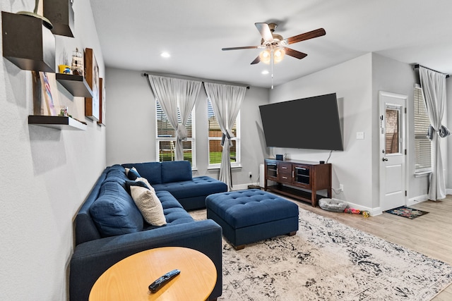 living room with hardwood / wood-style flooring and ceiling fan