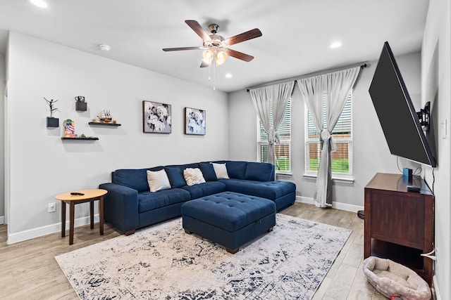 living room with ceiling fan and light wood-type flooring