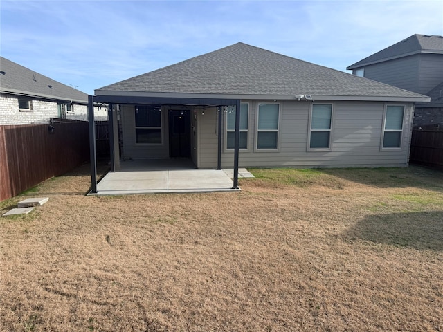 back of house with a patio and a lawn