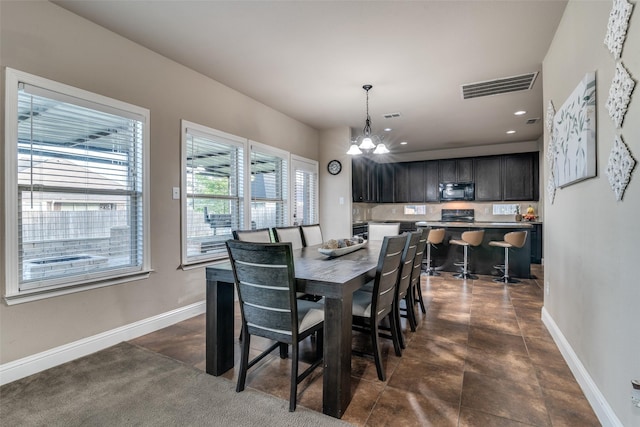 dining area with an inviting chandelier