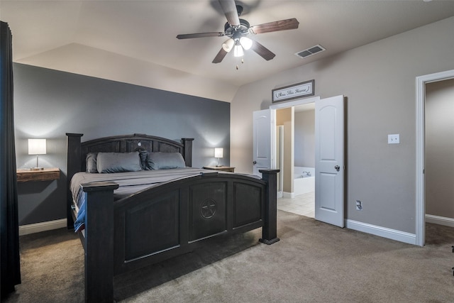 bedroom with lofted ceiling, light carpet, ceiling fan, and ensuite bath