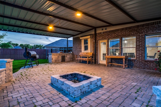 view of patio / terrace with area for grilling, a grill, and an outdoor fire pit