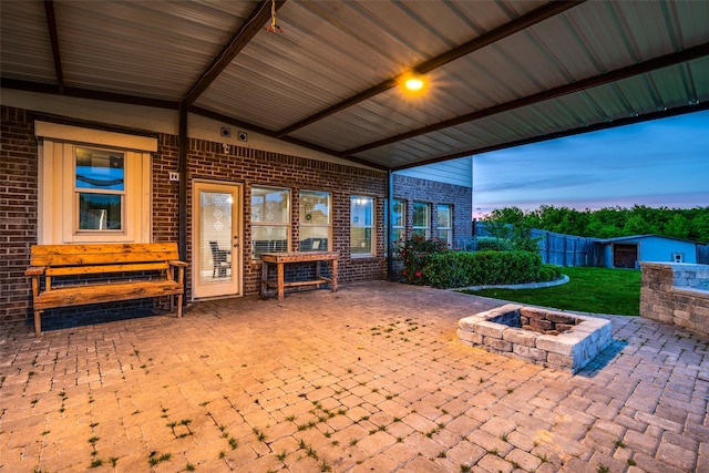 patio terrace at dusk featuring an outdoor fire pit