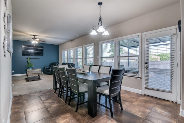 dining room with ceiling fan with notable chandelier and a wealth of natural light