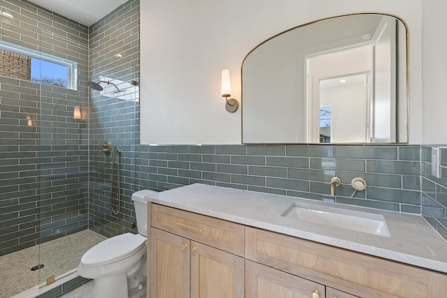 bathroom with toilet, a tile shower, tile walls, and decorative backsplash