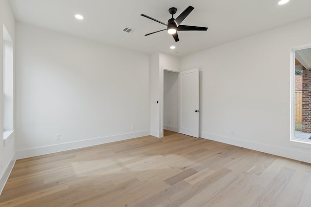 unfurnished room with ceiling fan and light wood-type flooring