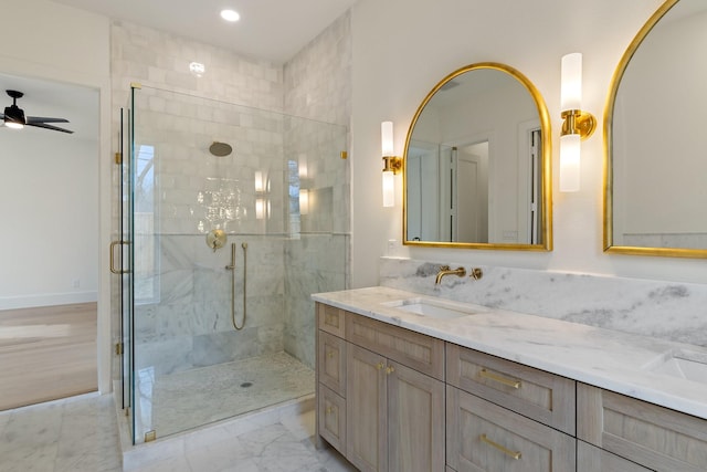 bathroom featuring ceiling fan, an enclosed shower, and vanity